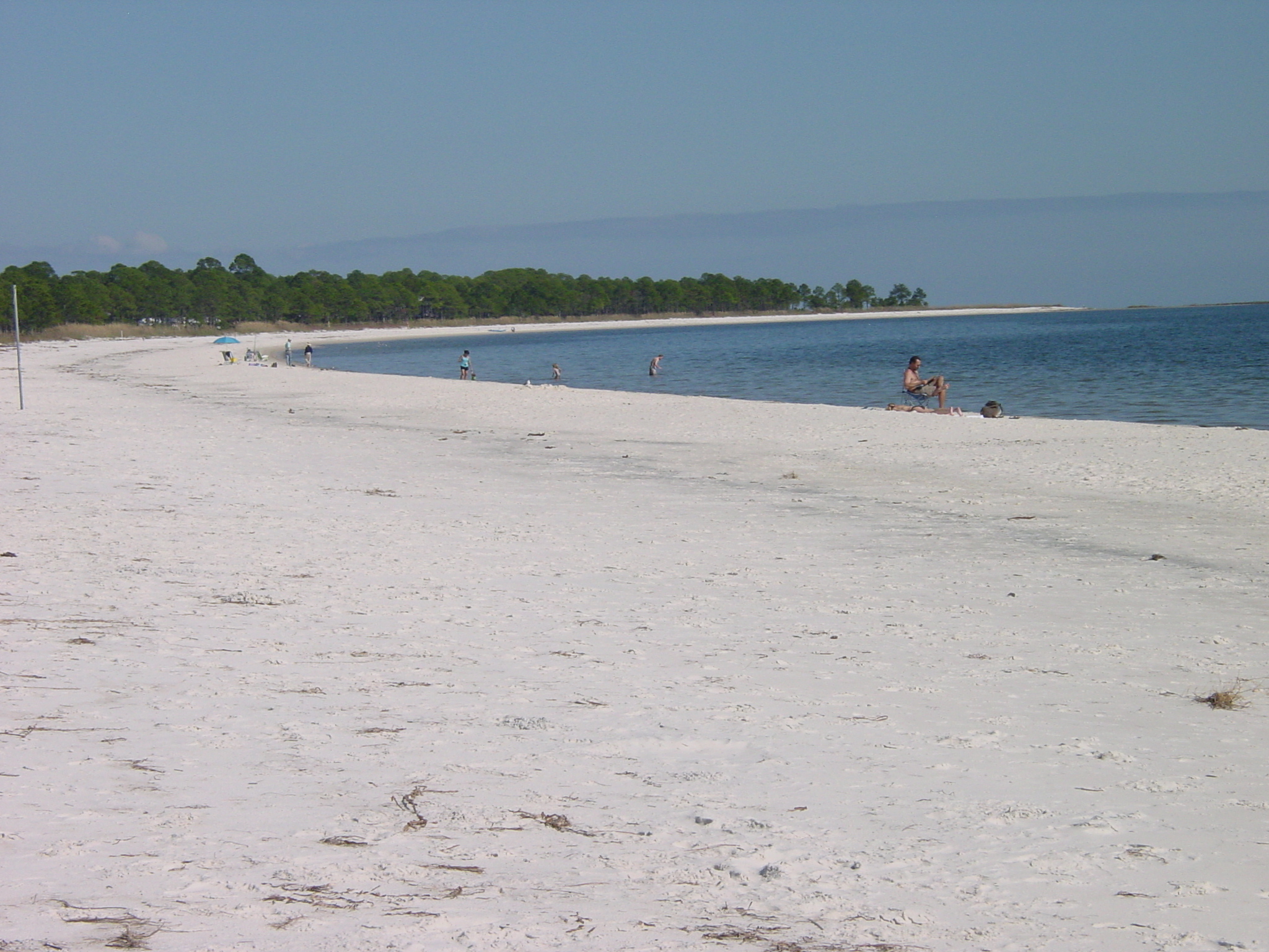 The wide white sand beach and calm Gulf water at Carrabelle Beach, Florida