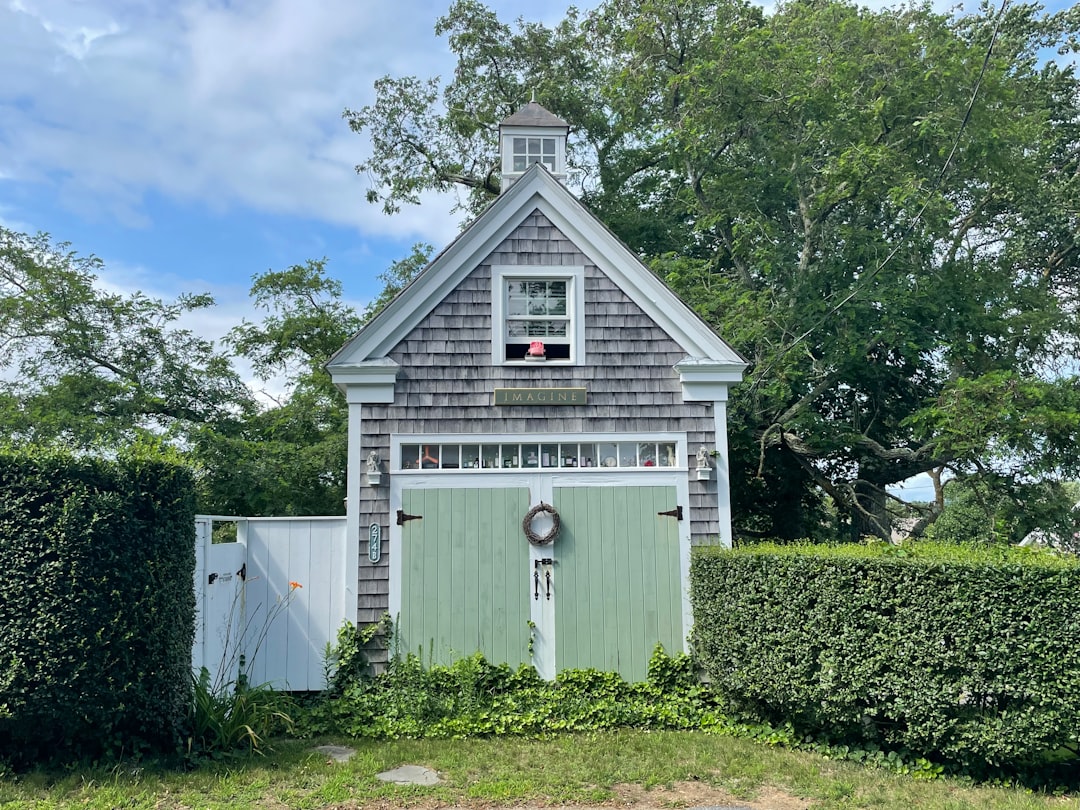 A grey-shingled Cape Cod cottage with hydrangeas in Chatham, Massachusetts