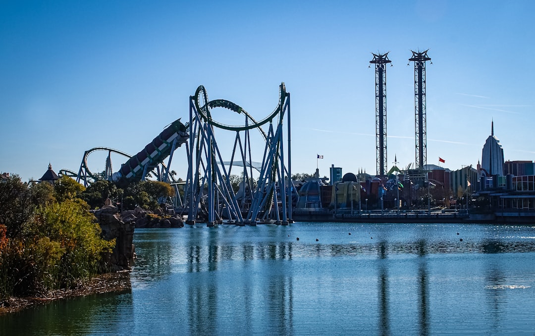 Roller coasters at an Orlando theme park under a bright blue sky