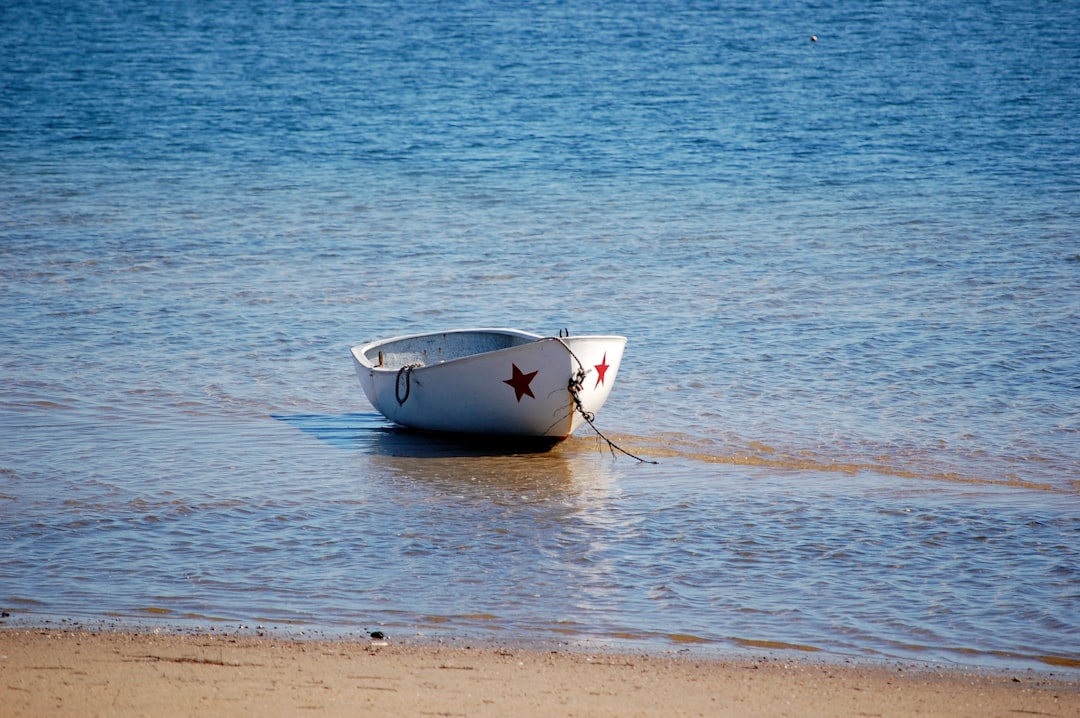 A small rowboat resting on the calm shore at Provincetown, Massachusetts