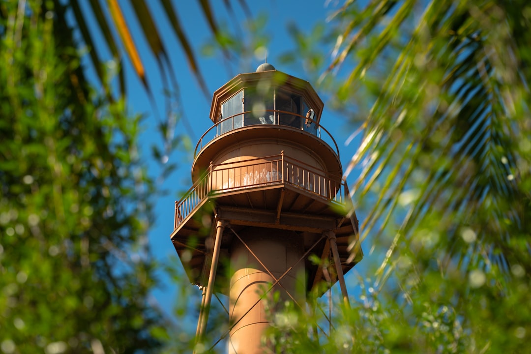 The Sanibel Island Lighthouse framed by palms in Florida