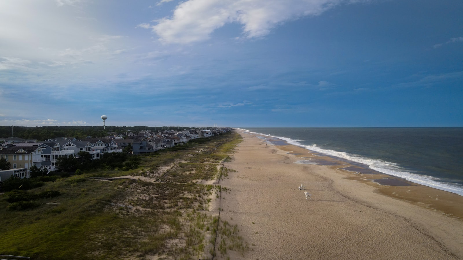 The wide sand and dune line behind the beach houses at Bethany Beach, Delaware