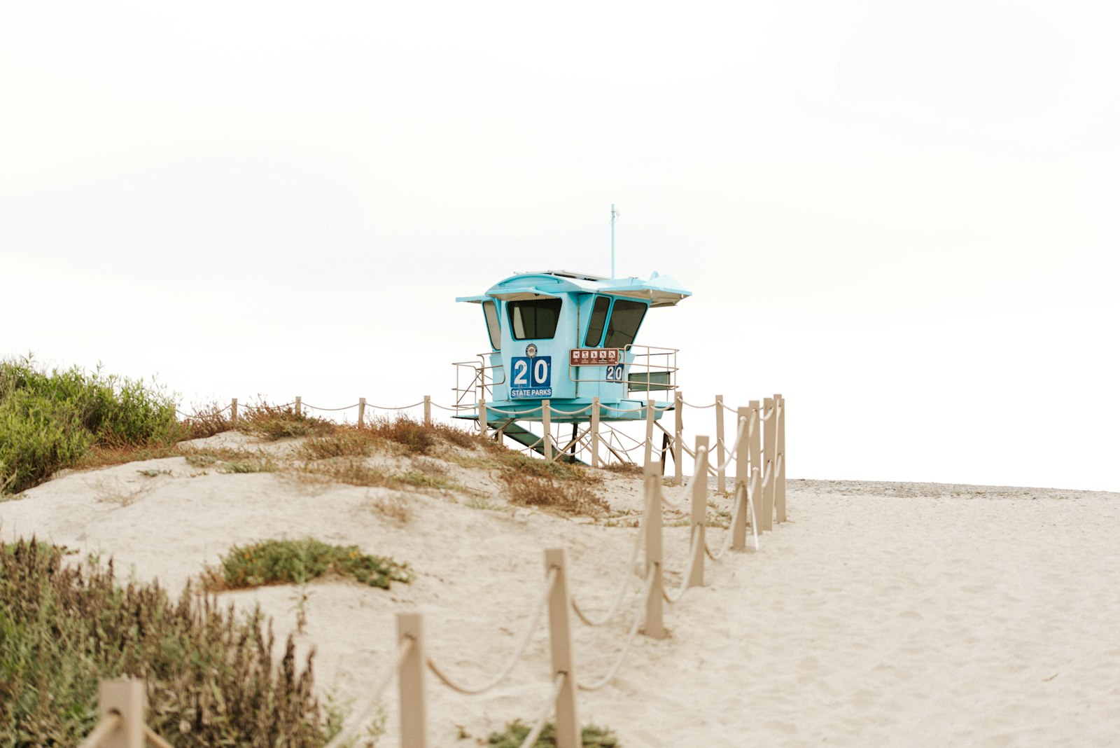 A state park lifeguard tower above the dunes at Carlsbad, California