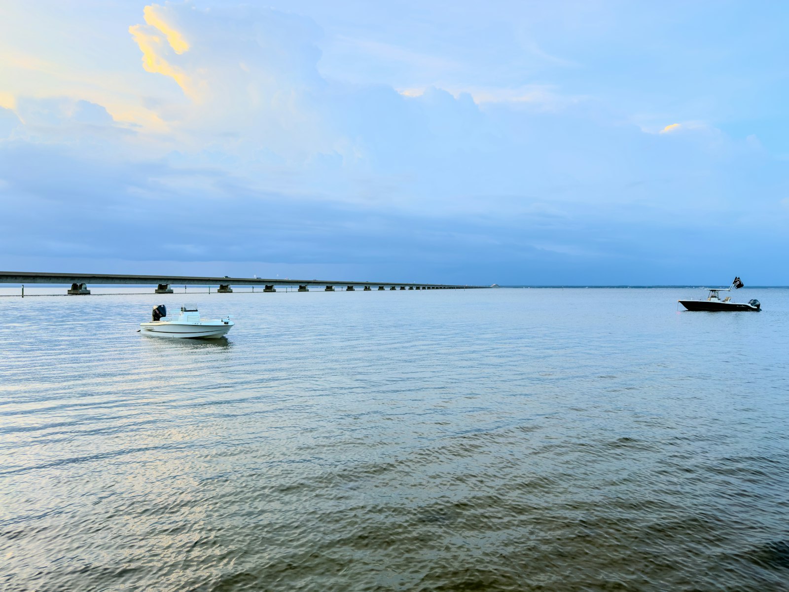 Small boats on the calm bay below the bridge at Eastpoint, Florida