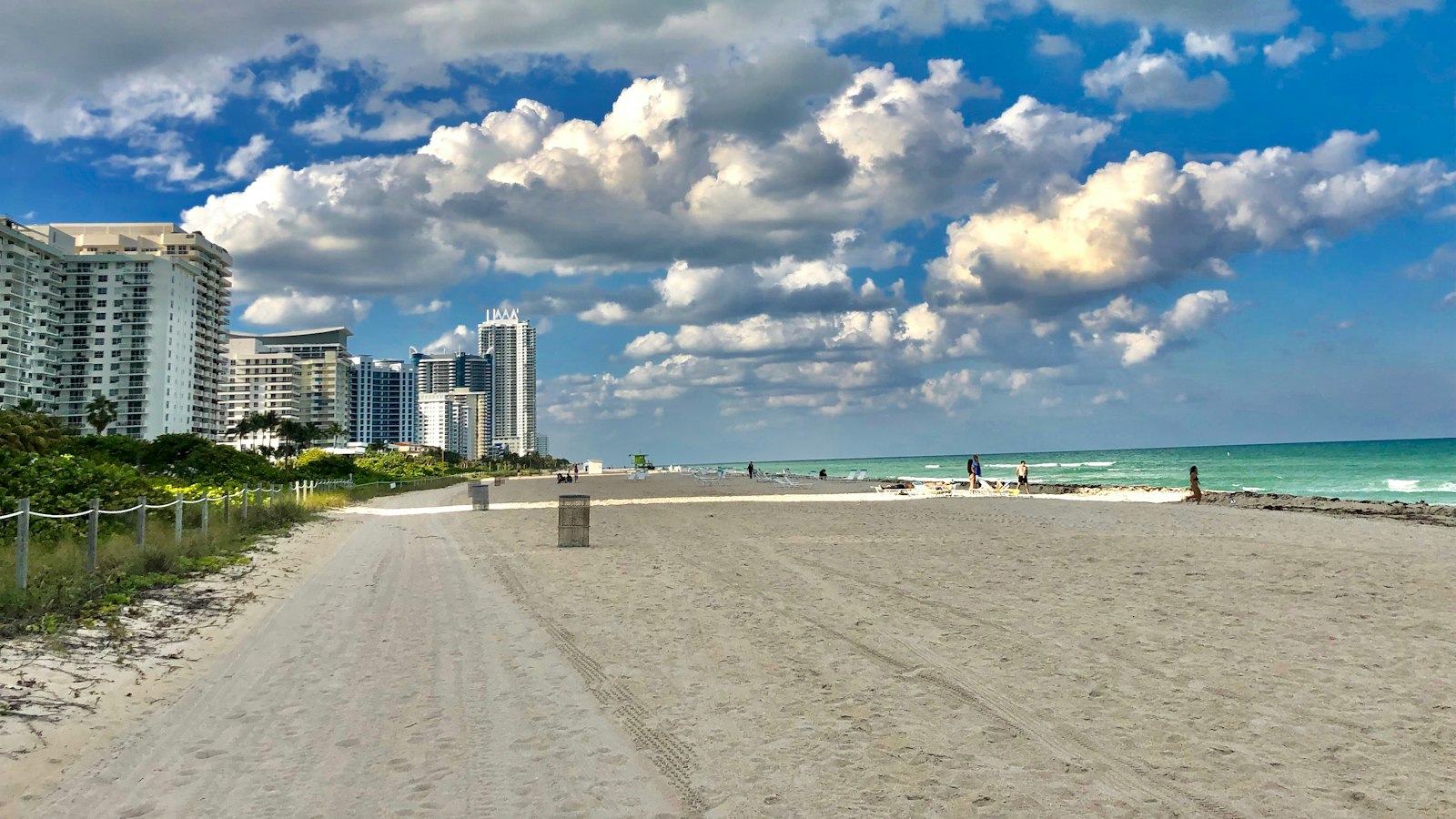 Wide white sand beach in Hollywood, Florida with oceanfront condo towers and turquoise Atlantic water