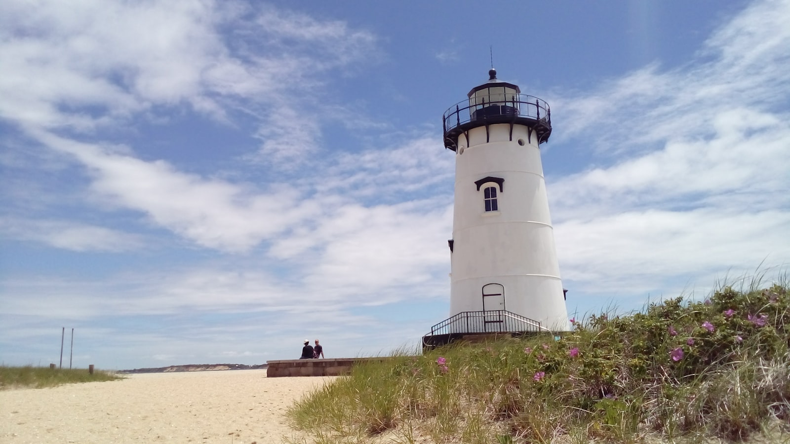 The Edgartown Harbor Lighthouse above the sand and beach roses on Martha’s Vineyard, Massachusetts